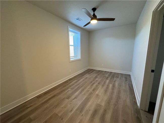 Spare room featuring dark wood finished floors and a ceiling fan | Image 57
