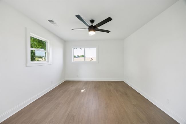 Spare room featuring wood finished floors and ceiling fan | Image 13