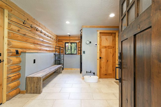 Bathroom with log walls, recessed lighting, a textured ceiling, and baseboards | Image 12