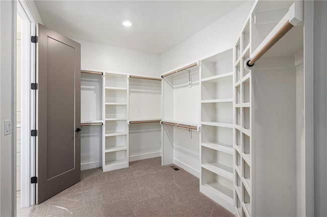 Walk in closet featuring carpet flooring | Image 34