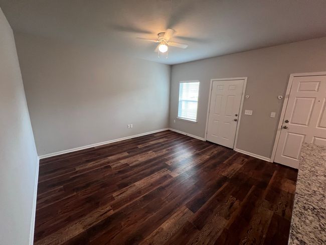 Foyer entrance featuring dark wood-style flooring, a ceiling fan, and baseboards | Image 13