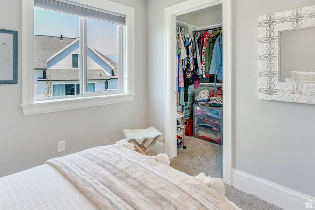 Carpeted bedroom with a spacious closet, a closet, and multiple windows | Image 47