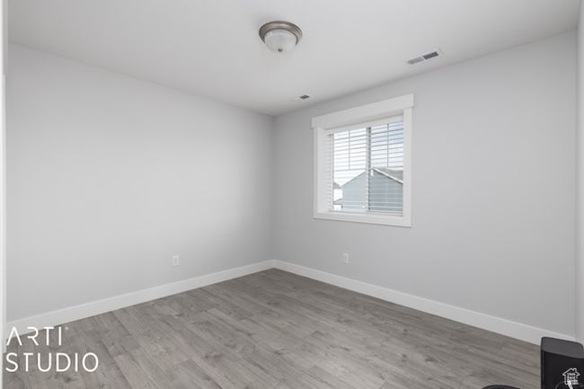 Unfurnished room with visible vents, baseboards, and wood finished floors | Image 24