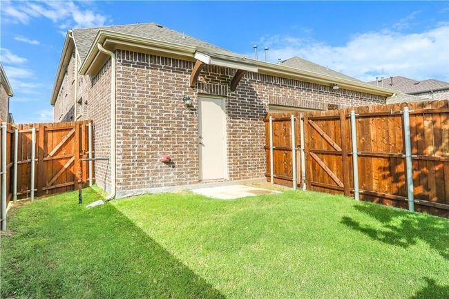 Back of house featuring a gate, brick siding, and a fenced backyard | Image 30