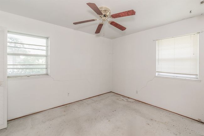 Spare room featuring ceiling fan and unfinished concrete floors | Image 22