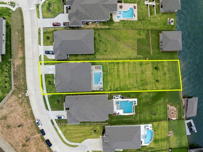 Expansive lakeside property on nearly half an acre, perfect for entertaining or relaxing. | Image 6