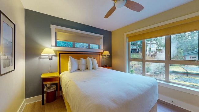Bedroom featuring multiple windows, baseboards, and wood finished floors | Image 25