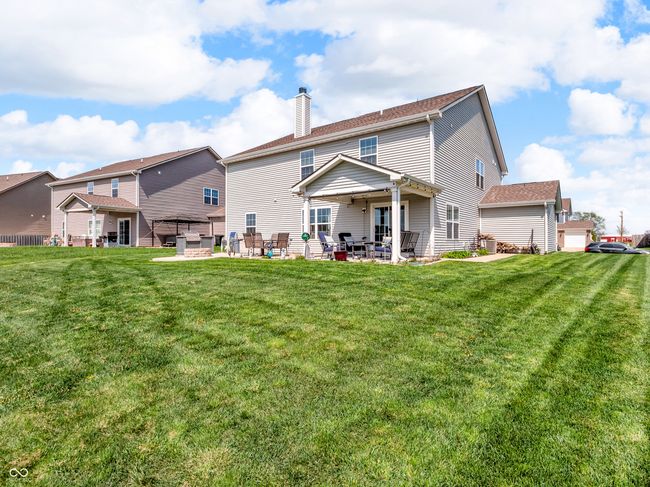back of property featuring the yard, and a patio. | Image 43