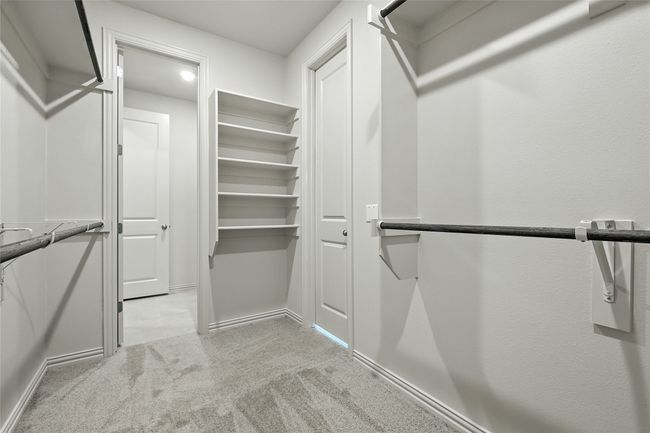 Walk in closet with light colored carpet | Image 25