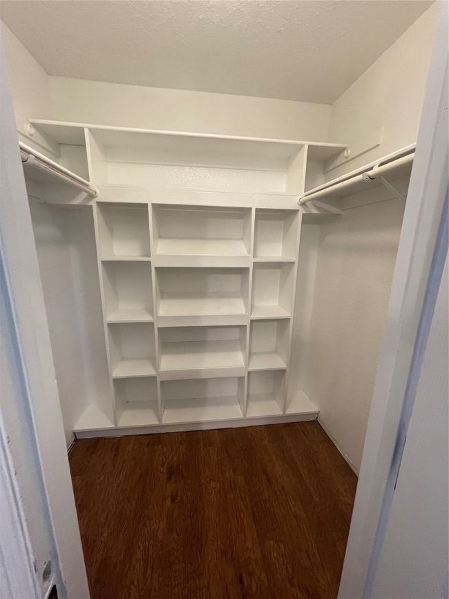 Spacious closet featuring dark wood-type flooring | Image 14