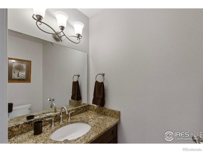 Main floor half bath is quietly tucked in by the front door and close to the kitchen. | Image 9