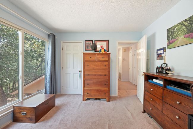 Carpeted bedroom featuring a textured ceiling | Image 24