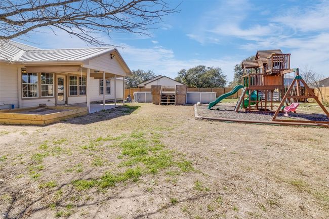 View of yard with a patio, a playground, and a fenced backyard | Image 26