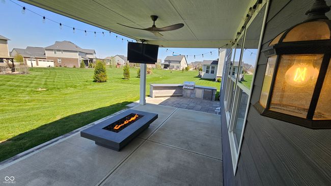 The covered patio features a linear fireplace and Outdoor TV! Dont miss the custom grilling island! These updates truly set this home apart from any on the market! | Image 5