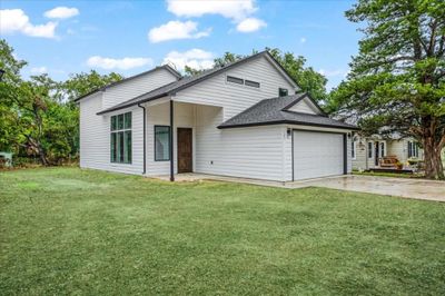 View of front of property featuring a front yard and a garage | Image 2