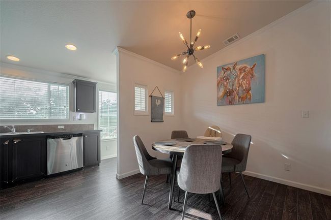 The designed space features elegant dining, perfect for family dinners and entertaining guests. | Image 11