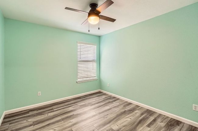Unfurnished room with baseboards, a ceiling fan, and wood finished floors | Image 21