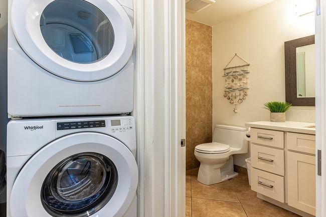 The stacked washer & dryer are adjacent to the 2nd bathroom | Image 25