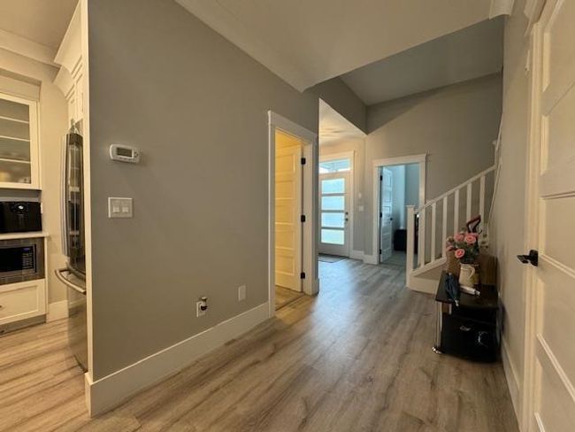 Interior space featuring light wood-style flooring, stairs, and baseboards | Image 16