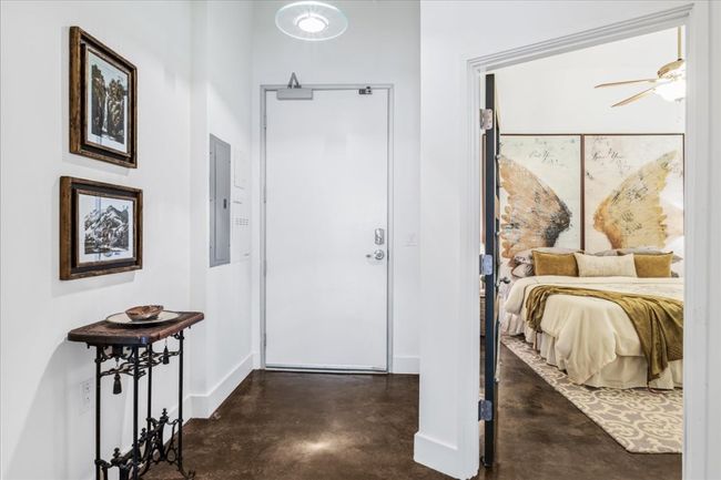 Foyer entrance with stained concrete floors and electric panel | Image 25