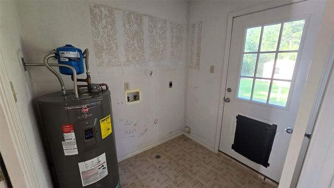 Laundry area featuring water heater, hookup for an electric dryer, washer hookup, and brick patterned floors | Image 11
