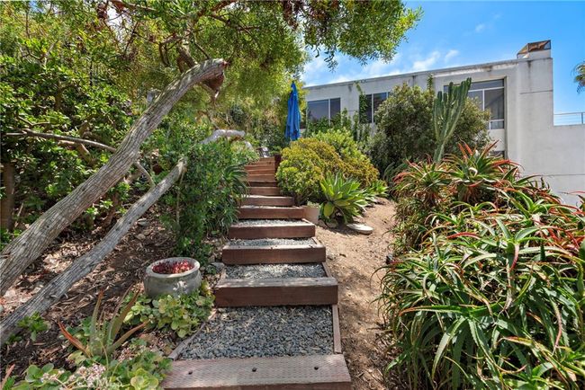 Stairs to sitting area above house. | Image 21
