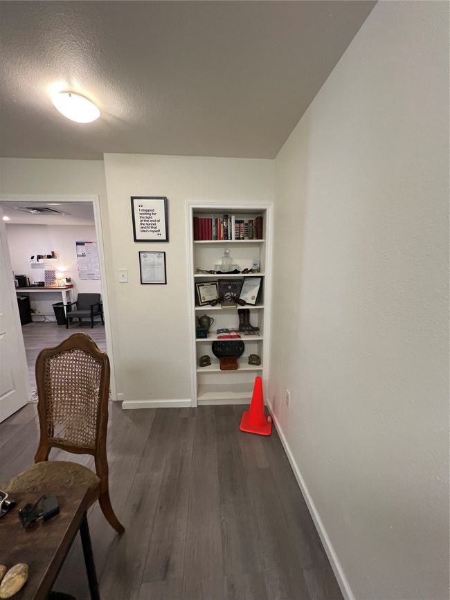 Hall with baseboards, dark wood-type flooring, and a textured ceiling | Image 28