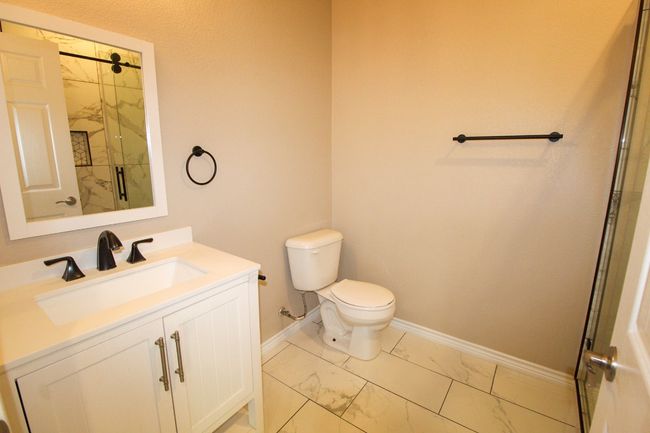 Full bathroom featuring marble finish floors and vanity | Image 15
