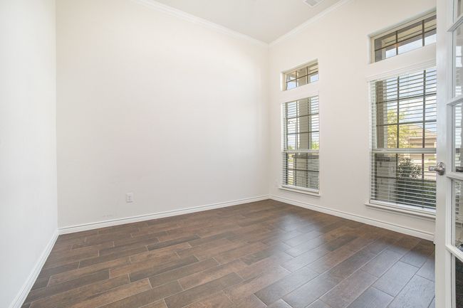 Unfurnished room featuring dark wood-style floors, baseboards, and ornamental molding | Image 13