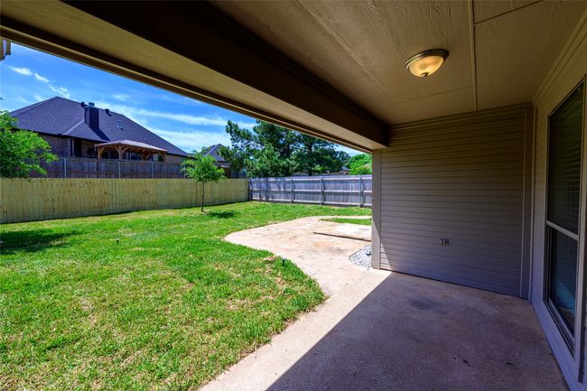 View of yard with a fenced backyard and a patio | Image 25