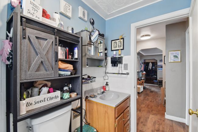 Bathroom with wood finished floors, vanity, and toilet | Image 10