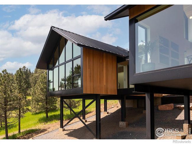 Steel beam elevated structure with hand-stained, rot-resistant thermally-modified solid wood siding | Image 33