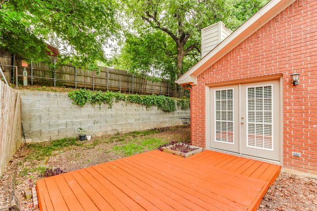 Deck featuring french doors and a fenced backyard | Image 27
