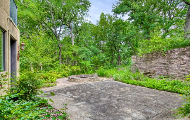 Patio courtyard area with fire pit. | Image 30