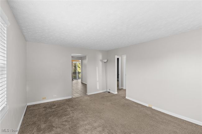 Carpeted spare room with baseboards and a textured ceiling | Image 7