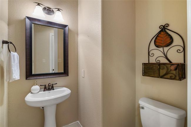 Lovely half bathroom ideally located coming in from the oversized garage. | Image 40