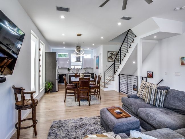 Living room featuring a ceiling fan, light wood-type flooring, stairway, and recessed lighting | Image 6
