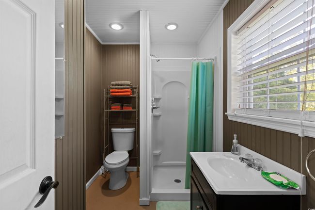 Bathroom featuring a shower stall, toilet, vanity, and recessed lighting | Image 33