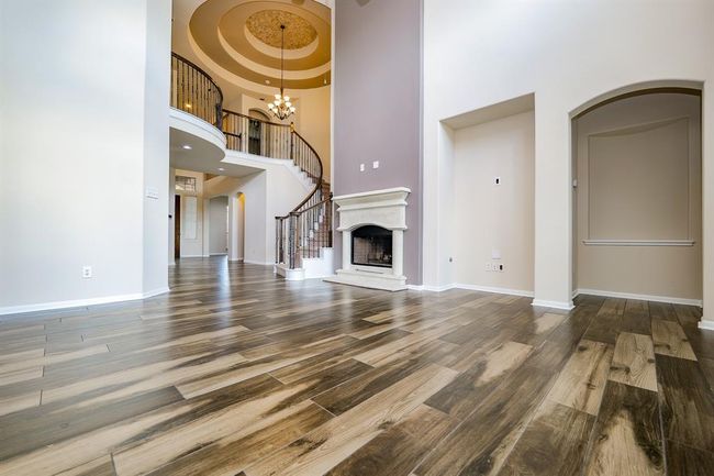 The word 'showplace' comes to mind, even if you think of this completely royal living area, as a casual retreat for family and friends! Heavenly high ceilings embrace spectacular views, below, in living and foyer areas, highlighted, up center, by a sublime view of the grand spiral wrought iron staircase, nestled below a stunning domed ceiling. | Image 7