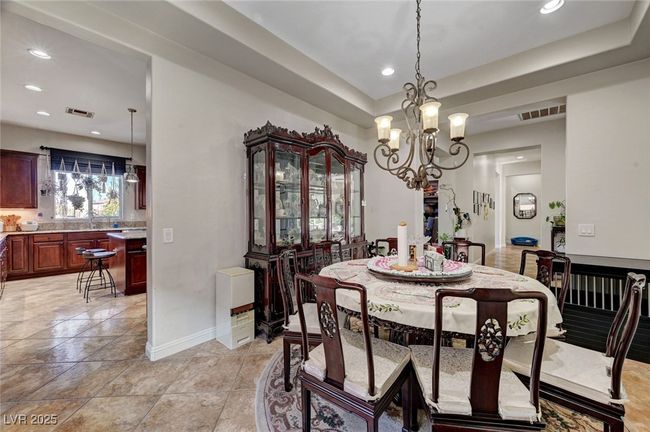 Formal dining room accented with a chandelier and trey ceilings | Image 25
