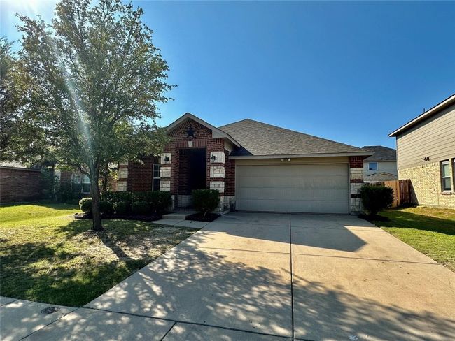View of front of home with a garage, concrete driveway, brick siding, a front lawn, and roof with shingles | Image 16
