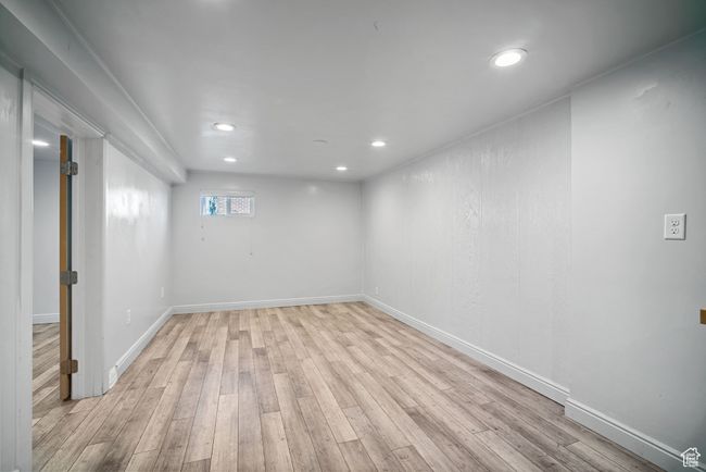 Below grade area with light wood-type flooring, recessed lighting, and baseboards | Image 19