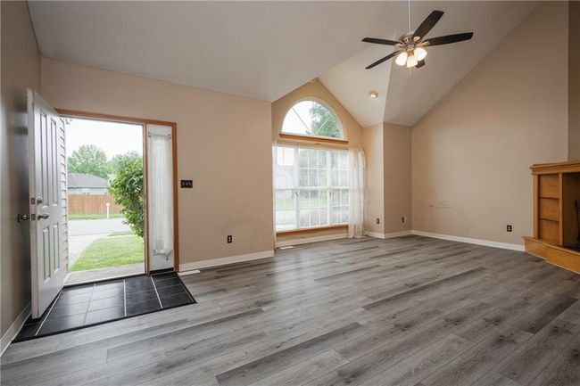 Entrance foyer with wood finished floors, ceiling fan, lofted ceiling, and baseboards | Image 6