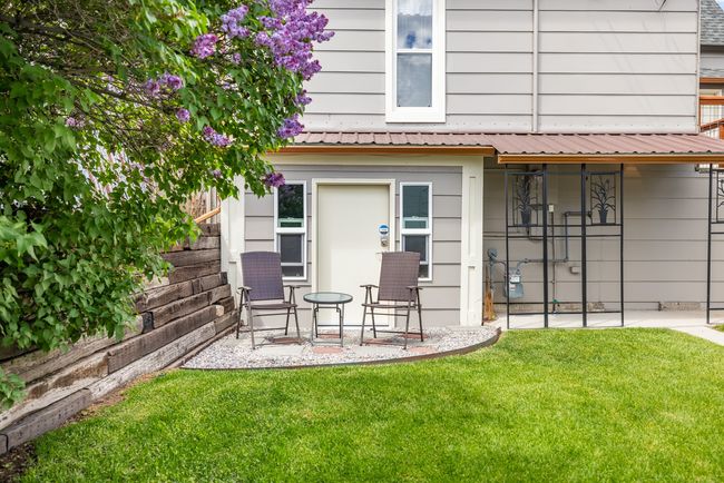 Rear view of house with a yard and metal roof | Image 4