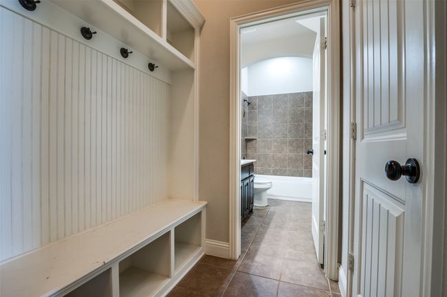 Mudroom with dark tile patterned flooring and baseboards | Image 19