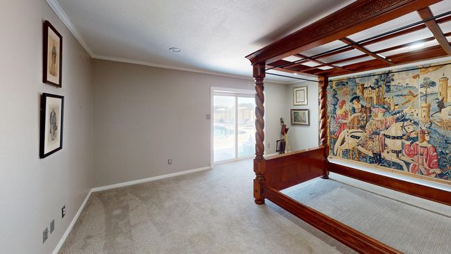 Carpeted bedroom with access to exterior, baseboards, and crown molding | Image 14