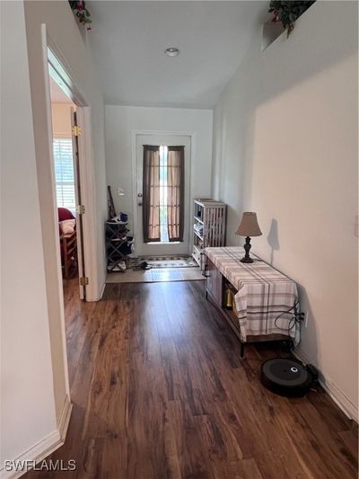 Hall featuring dark wood-type flooring and a wealth of natural light | Image 3