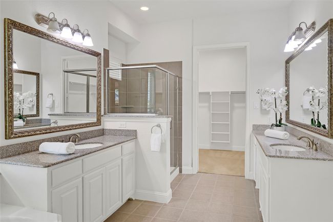 Bathroom with a stall shower, a spacious closet, double vanity, tile patterned floors, and recessed lighting | Image 14