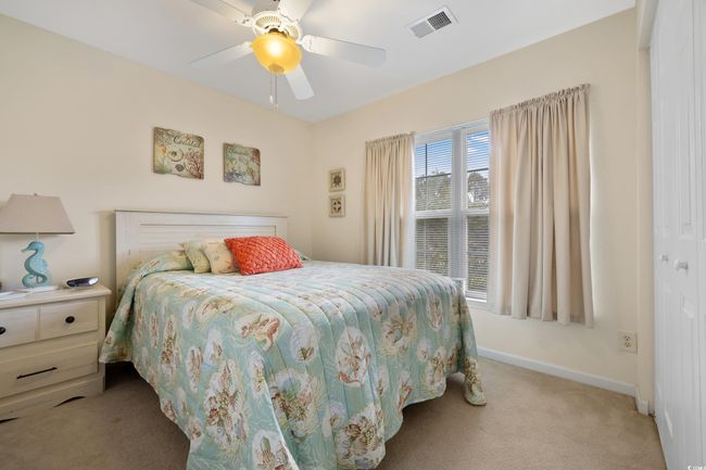 Bedroom featuring light carpet, baseboards, and a ceiling fan | Image 27