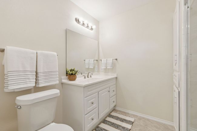 Primary Ensuite Bathroom with double vanities, dual sinks, and frameless walk-in shower | Image 17